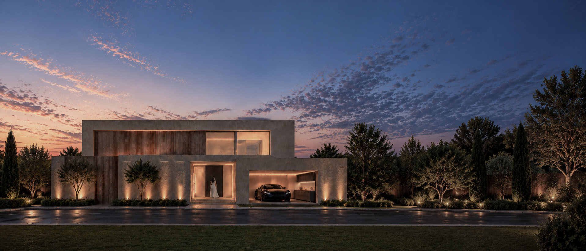 FBK House street facade at dusk with the lit entrance and garage